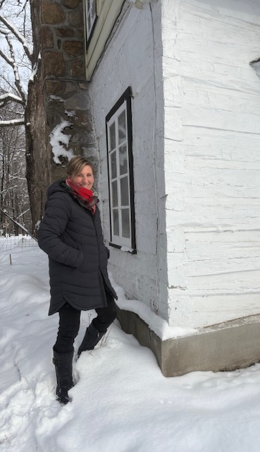 Ginette Mayer devant la maison Ivall, restaurée par elle et son conjoint, un travail complété en 2024.